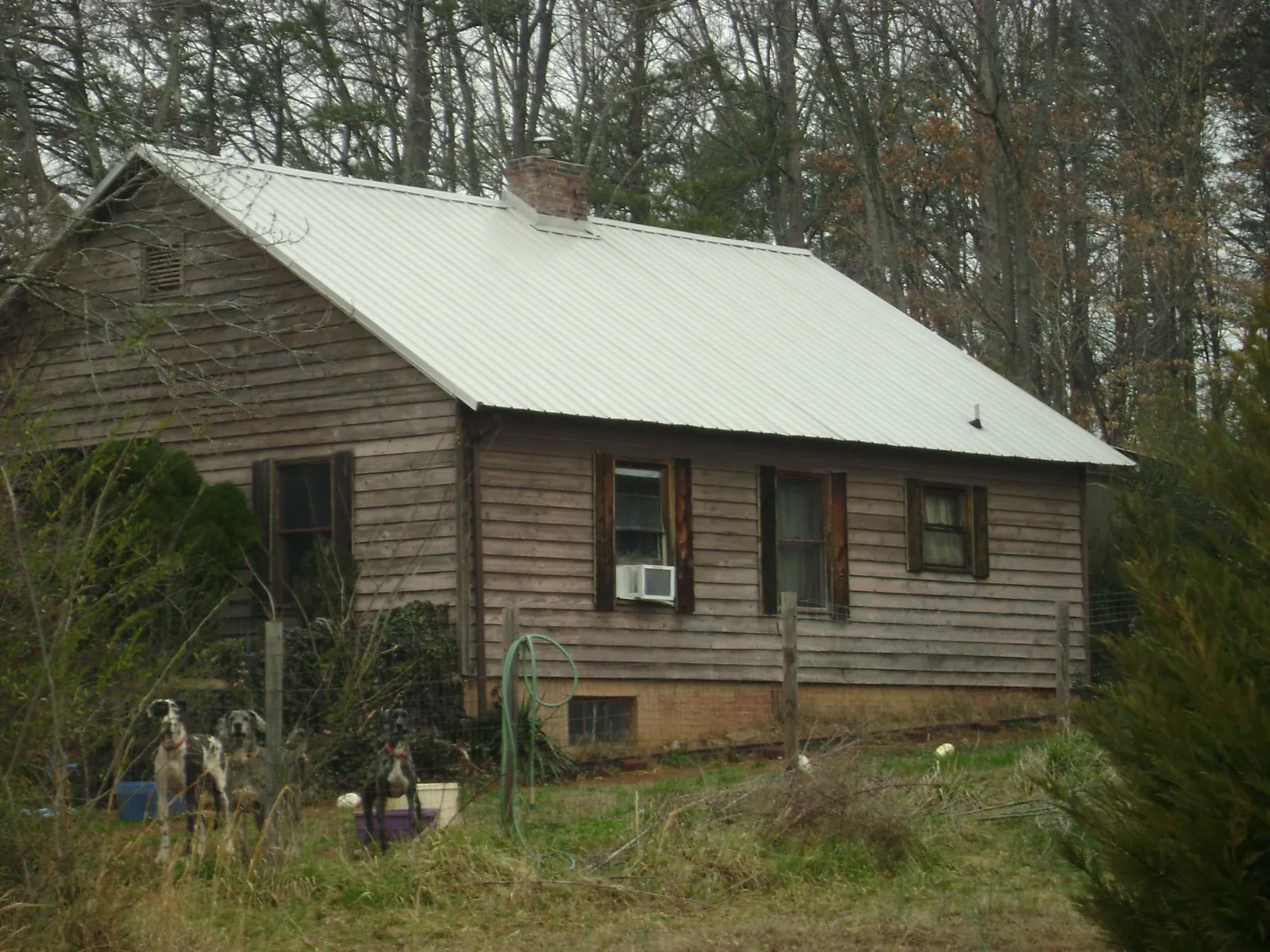 White metal roof on an old wood sided farmhouse, from a Metal Roof Installation job in Penn Yan